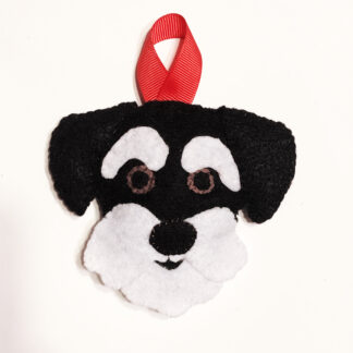 schnauzer ornament shows bearded dog on red hanging loop